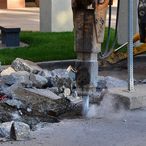 tractor-jackhammering-concrete